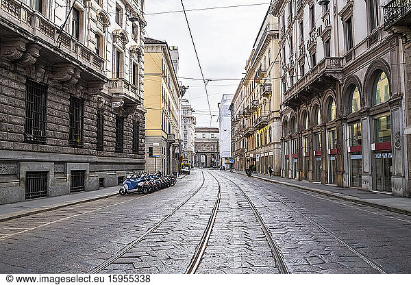 Italy  Milan  Railroad tracks stretching along empty city street during COVID-19 outbreak
