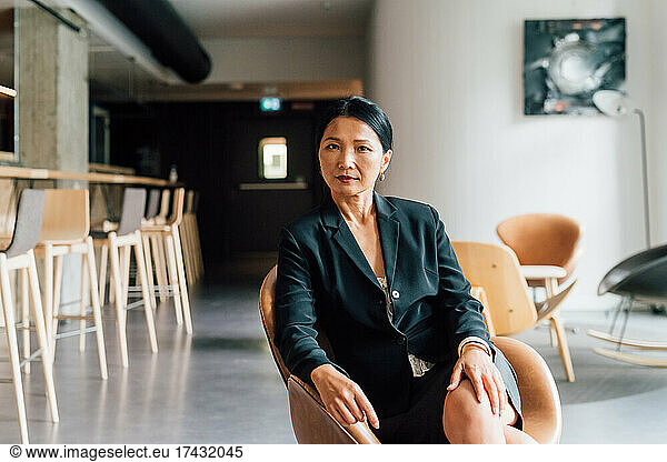Italy  Portrait of businesswoman sitting in creative studio