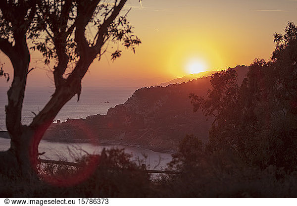Italy  Province of Livorno  Elba  Coastal cliffs at moody sunset