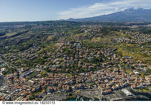 Italy  Sicily  Aci Trezza  Aerial view of coastal town with Mount Etna in distant background