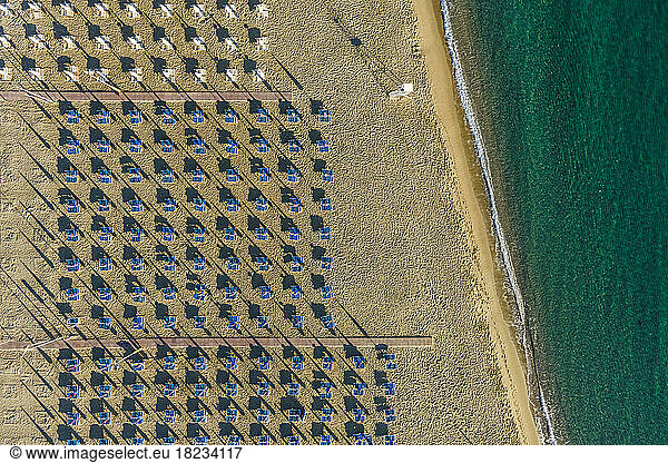 Italy  Sicily  Giardini Naxos  Aerial view of rows of umbrellas along empty beach