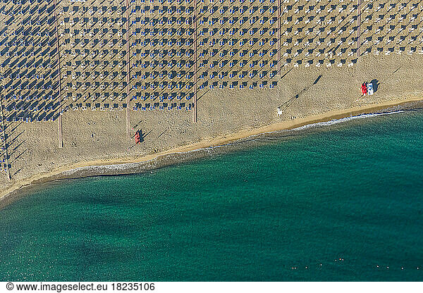 Italy  Sicily  Giardini Naxos  Aerial view of rows of umbrellas along empty beach
