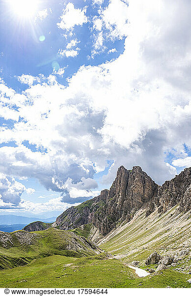 Italy  South Tyrol  Clouds over mountainous landscape of Schlern-Rosengarten Nature Park on sunny summer day