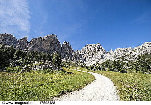 Italy  South Tyrol  Dirt road in Gardena Pass with Sella Group massif in background