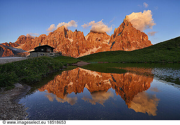 Italy  Trentino-Alto Adige  Pale di San Martino massif reflecting in small lake at dusk