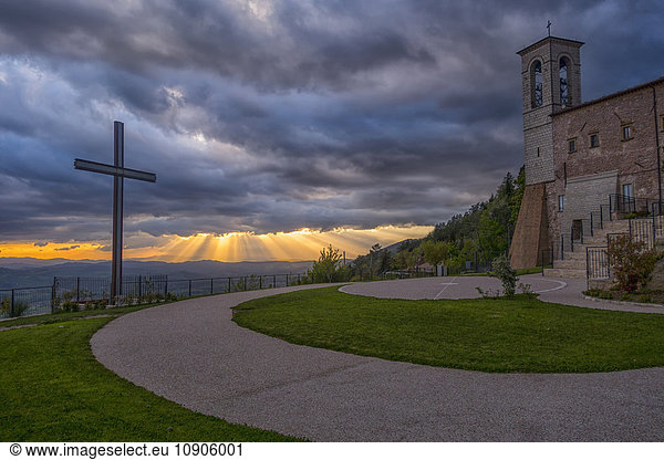 Italy  Umbria  Apennines  Gubbio  Cross and Church of Saint Ubaldo at sunset
