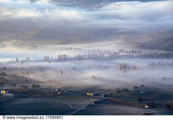 Italy  Umbria  Gubbio  Countryside fields shrouded in thick morning fog