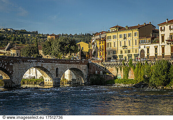Italy  Veneto  Verona  Arch bridge over Adige river with city houses in background