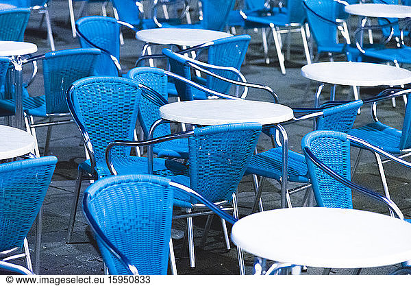 Italy  Venice  Empty chairs and tables standing outdoors