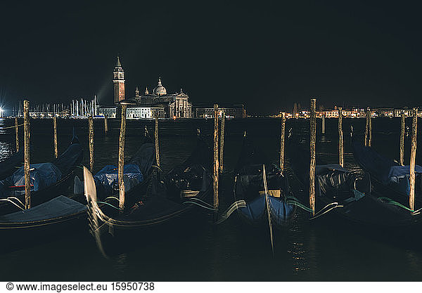 Italy  Venice  Row of moored gondolas at night