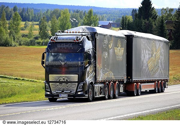 JAMSA  FINLAND - AUGUST 23  2018: The spectacular show truck Volvo FH16 Ace of Spades transports load on scenic road in Central Finland in late summer.