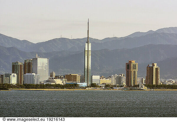 Japan  Fukuoka Prefecture  Fukuoka City  Coastal skyscrapers with mountains in background