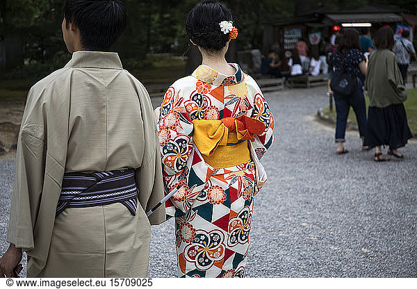 Japan  Ishikawa Prefecture  Kanazawa  Couple wearing traditional yukatas walking together in Kenroku-en garden