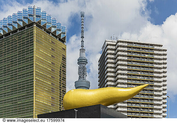 Japan  Kanto Region  Tokyo  View of Asahi Beer Hall with Asahi Flame in foreground and Tokyo Skytree in background