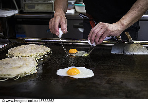 Japan  Kyoto  Close-up of chef preparing Okonomiyaki in restaurant