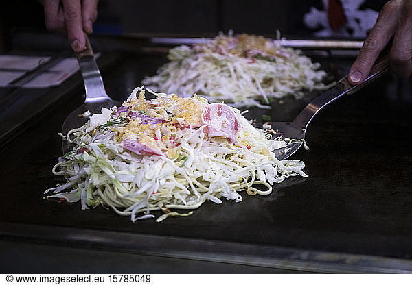 Japan  Kyoto  Close-up of chef preparing Okonomiyaki in restaurant