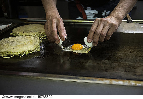Japan  Kyoto  Close-up of chef preparing Okonomiyaki in restaurant