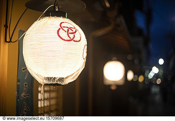 Japan  Kyoto Prefecture  Kyoto City  Glowing lantern illuminating night street