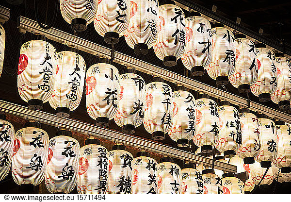 Japan  Kyoto Prefecture  Kyoto City  Rows of lanterns glowing in Japanese temple at night