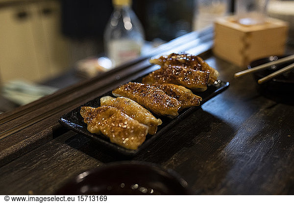 Japan  Takayama  Tray with fried gyozas served in traditional Japanese restaurant