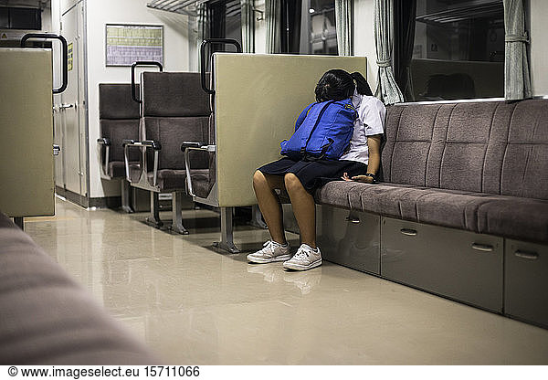 Japan  Tokyo  Schoolgirl resting on train