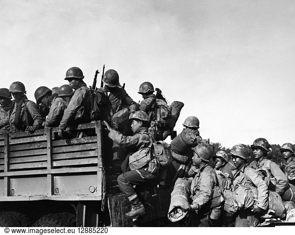 JAPANESE-AMERICAN TROOPS. Japanese-American troops of the 442nd Combat Team climb into the back of a truck as they prepare to move their bivouac area in France  14 October 1944.