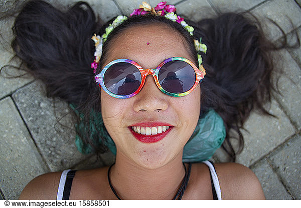 Japanese descent lying on the floor and smiling during carnival