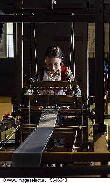 Japanese young woman weaving at the loom  Hida Minzoku Mura  Hida no Sato  Takayama  Japan  Asia
