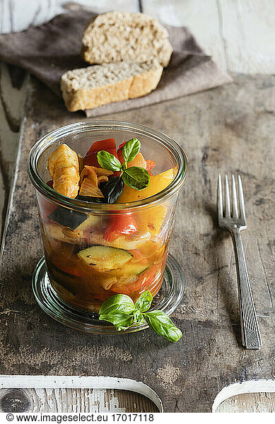 Jar of French ratatouille with asparagus and basil