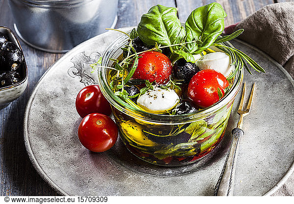 Jar of fresh Caprese salad preserved in olive oil