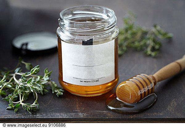 Jar of honey with herbs