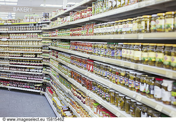 Jars of food lining shelves in supermarket