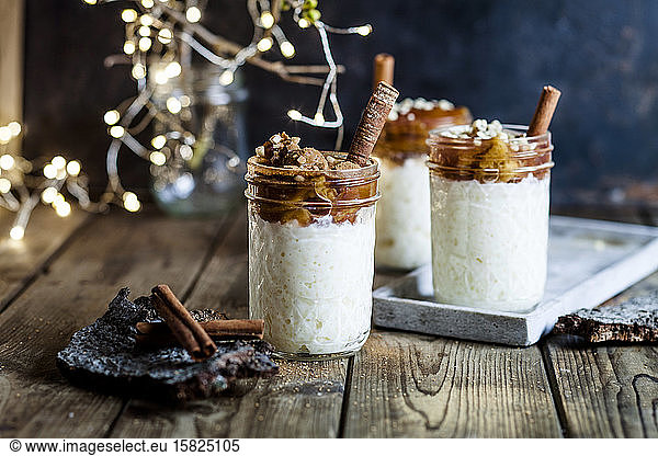 Jars of rice pudding with cinnamon and roasted plums