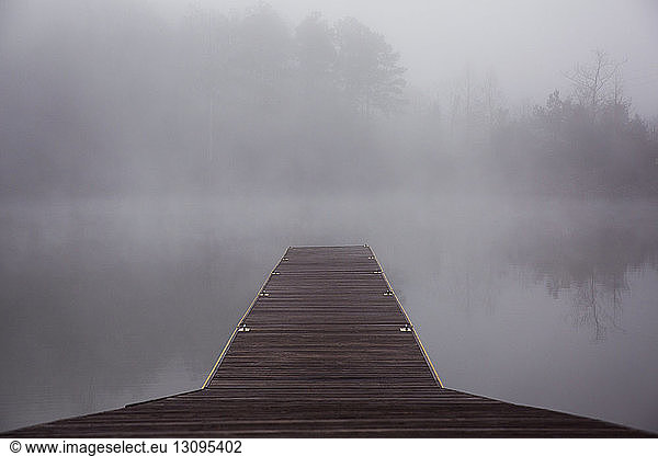 Jetty on foggy lake