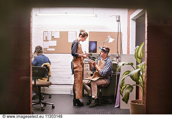 Jewelers talking in workshop office