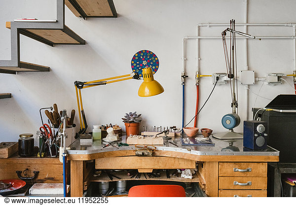 Jewellery making equipment and tools on jewellery workshop workbench