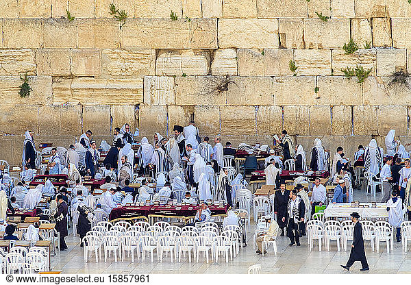 Jewish men praying at the Western Wall on the last day of Passover