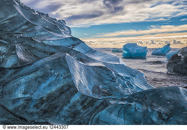 Jokulsarlon or Diamond Beach  with large chunks of ice littering the beach between each high tide  Iceland