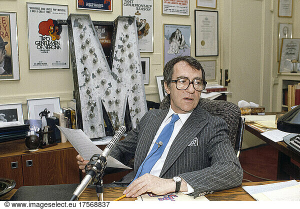 Joseph Papp (1921-1991)  American Theatrical Director and Producer  half-length portrait sitting at Desk  Bernard Gotfryd  1982