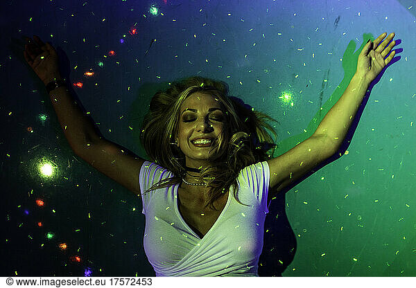 Joyful woman on floor with lights