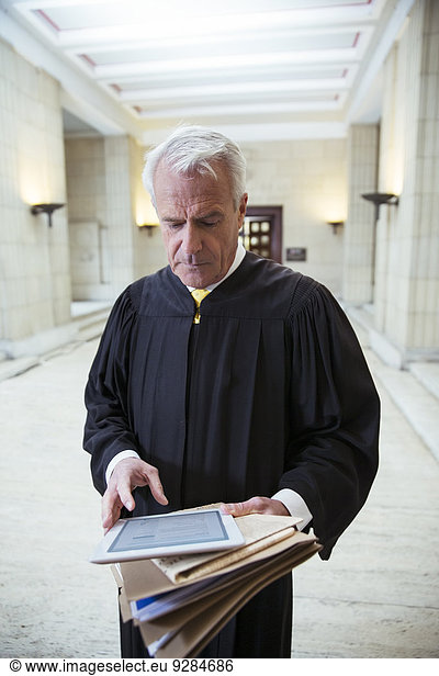 Judge using digital tablet in courthouse