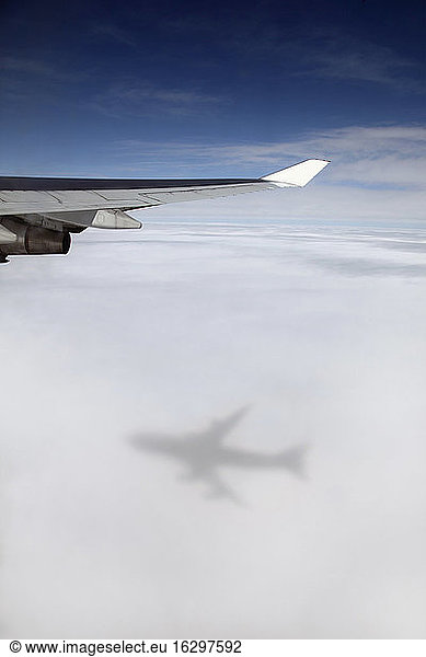 Jumbo jet  Boeing 747 in mid-air  view at clouds shadow of the airplane