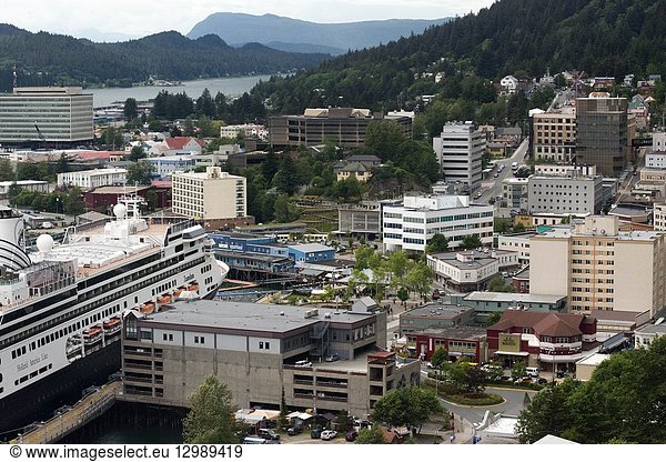 Juneau downtown  city. Alaska. USA. Cruises ship dockeds between snow capped mountains and the Mount Roberts Tramway in Juneau dock  Alaska  USA. Cruise Ship Terminal and Mt Roberts Tramway  Alaska  Inside Passage  United States of America. The City and Borough of Juneau is the capital city of Alaska. It is a unified municipality located on the Gastineau Channel in the Alaskan panhandle  and is the second largest city in the United States by area. Juneau has been the capital of Alaska since 1906  when the government of what was then the District of Alaska was moved from Sitka as dictated by the U. S. Congress in 1900. The municipality unified on July 1  1970  when the city of Juneau merged with the city of Douglas and the surrounding Greater Juneau Borough to form the current home rule municipality. The area of Juneau is larger than that of Rhode Island and Delaware individually and is almost as large as the two states combined. Downtown Juneau is nestled at the base of Mount Juneau and across the channel from Douglas Island. As of the 2010 census  the City and Borough had a population of 31 275. In July 2013  the population estimate from the United States Census Bureau was 32 660  making it the second most populous city in Alaska after Anchorage. (Fairbanks is however the second-largest metropolitan area in the state  with more than 97 000 residents. ) Between the months of May and September  Juneau's daily population can increase by roughly 6 000 people from visiting cruise ships.