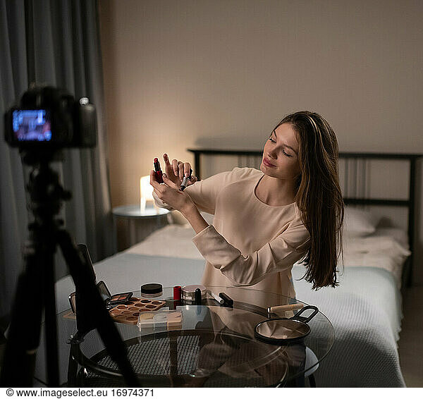 Junge Beauty-Bloggerin probiert Lippenstift vor der Kamera aus