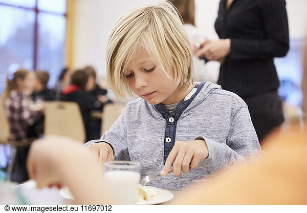 Junge beim Mittagessen in der Schulkantine