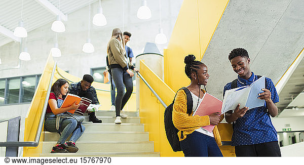 Junior high students talking and studying at stairs