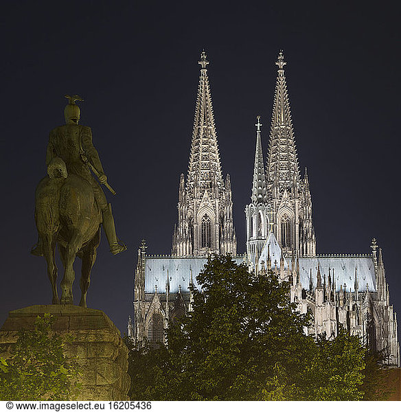 Kaiser Wilhelm II statue and Cologne Cathedral (Koelner Dom) at night  Cologne  Germany