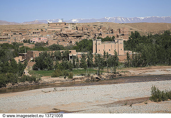 Kalaat M´Gouna mit Fluss und schneebedeckten Gipfeln des Atlasgebirges  Provinz Ourzazate  Marokko