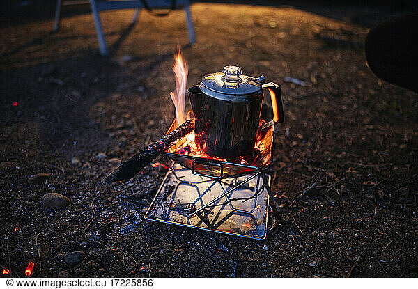 Kettle on camping stove at night