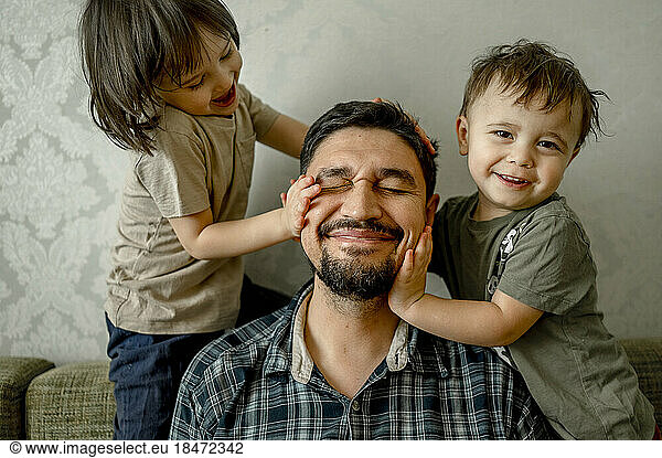 Kids playing with father at home